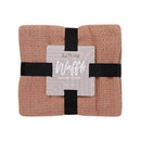 Lightweight blush cotton throw perfect for bed or sofa.