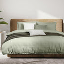 Moss green waffle quilt cover set with matching pillowcases on a neutral headboard bed.
