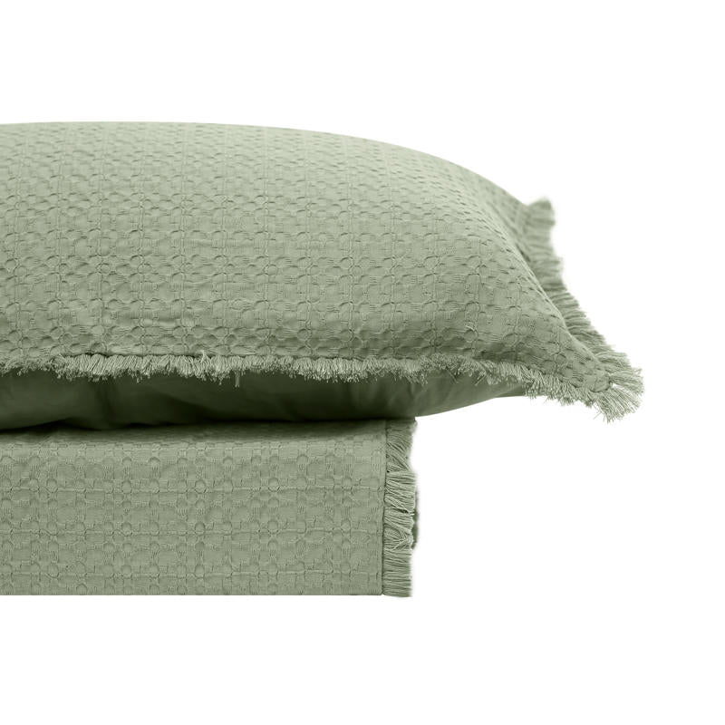 Moss green waffle quilt cover set with matching pillowcases on a neutral headboard bed.
