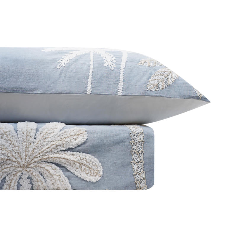 Light blue embroidered quilt cover set with matching pillowcases and natural décor