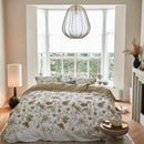 Nature-inspired floral quilt cover styled in a bright bedroom.