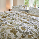 Nature-inspired floral quilt cover styled in a bright bedroom.
