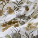 Nature-inspired floral quilt cover styled in a bright bedroom.
