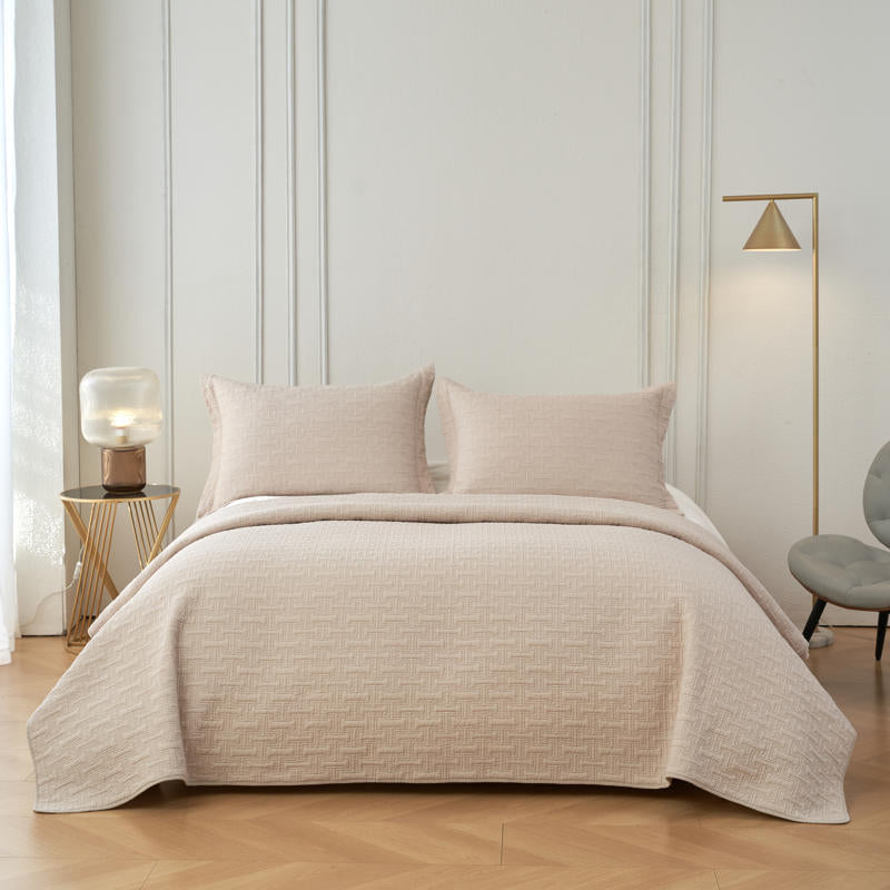 Soft neutral cotton throw with detailed stitching and bound edges.