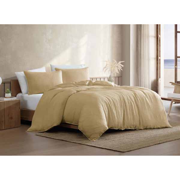 Warm yellow quilt cover set styled with coastal-inspired décor and ocean view.