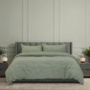 Ardor Boudoir Adeline Sage Quilt Cover Set styled on bed with textured chenille pattern.