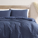 Navy seersucker quilt cover set adding a modern, relaxed look to the bedroom.