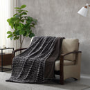 Ardor Boudoir Cole Ash Faux Fur Throw draped over a sofa in a modern living room