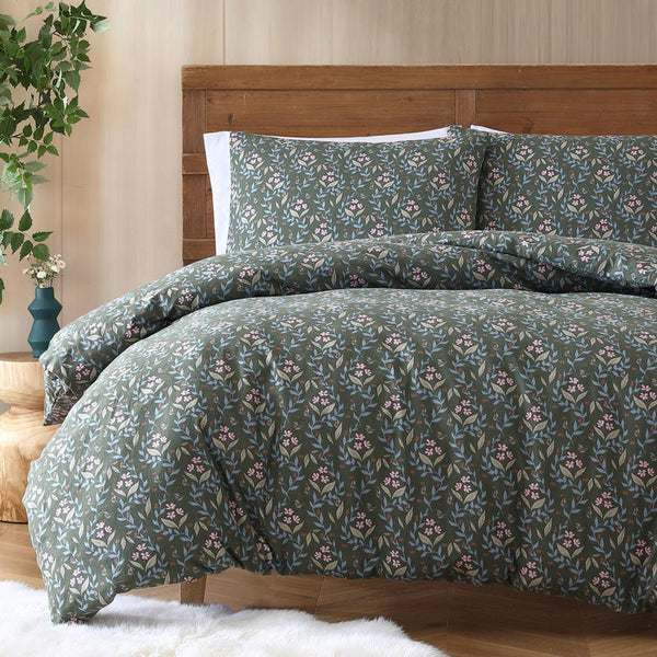 Charming ditsy floral design featuring soft pinks and blues on a deep green base, bringing a fresh, homely touch to your space.