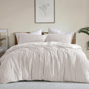 Neutral stripe quilt cover set creating a calm, minimal bedroom look.
