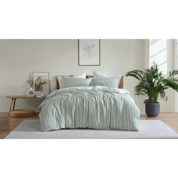 Coastal-inspired sage and white stripe quilt cover set in a relaxed modern bedroom.