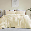 Bright and cheerful yellow stripe quilt cover set in a modern bedroom.