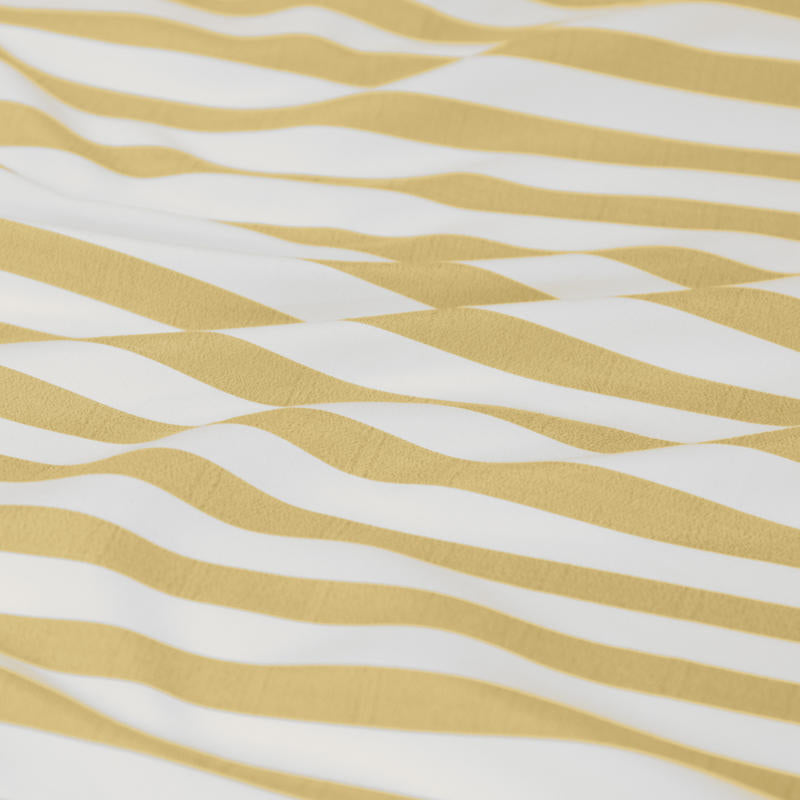 Bright and cheerful yellow stripe quilt cover set in a modern bedroom.
