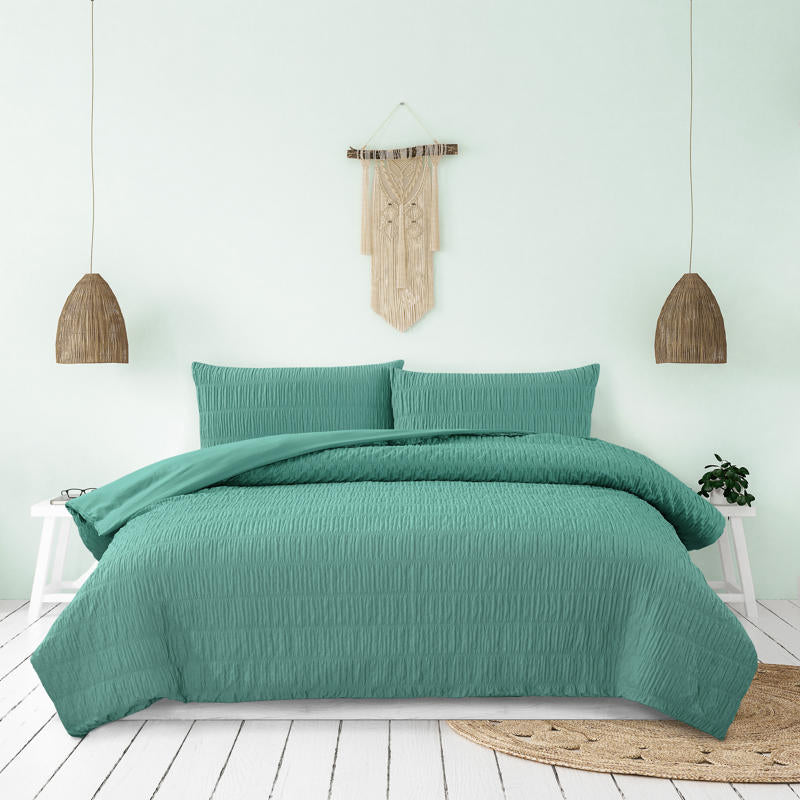 Teal quilt cover set creating a fresh, modern look in a coastal-inspired bedroom.