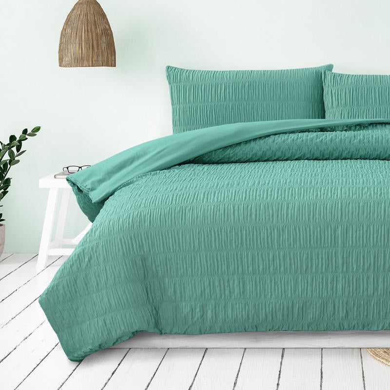 Teal quilt cover set creating a fresh, modern look in a coastal-inspired bedroom.