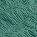 Teal quilt cover set creating a fresh, modern look in a coastal-inspired bedroom.