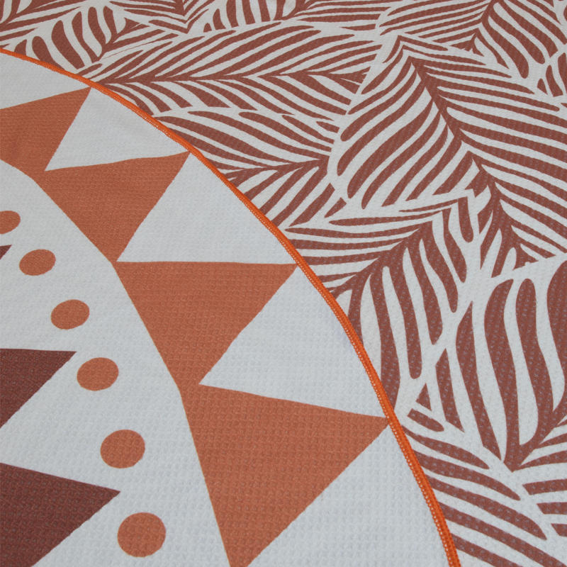 Reversible with two designs: a warm clay-toned leaf print and a bold geometric pattern.
