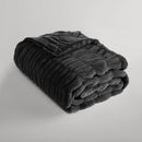 Luxurious black faux fur throw adding warmth and style to home décor.