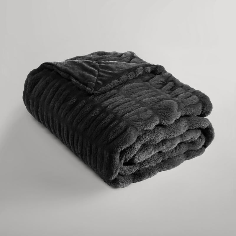 Luxurious black faux fur throw adding warmth and style to home décor.