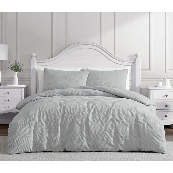 Soft silver quilt cover with matching pillowcases in modern bedroom.