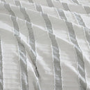 Close-up of soft textured green and white stripe detailing on the Miles Quilt Cover fabric.