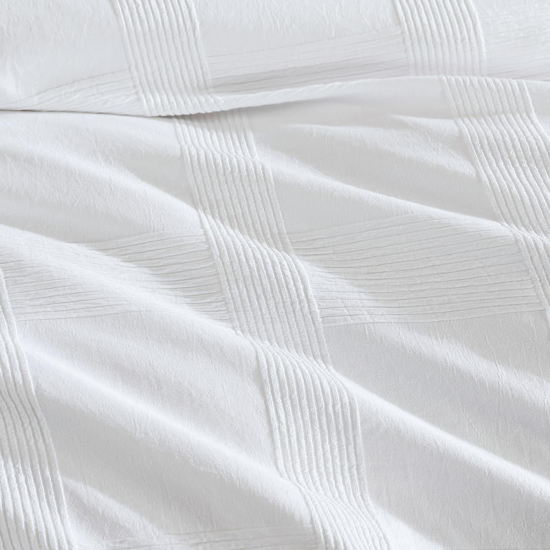 Close-up of textured check detailing on the Shiloh White Quilt Cover fabric.