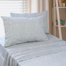 Close-up of playful blue sun print pattern on kids sheet set.