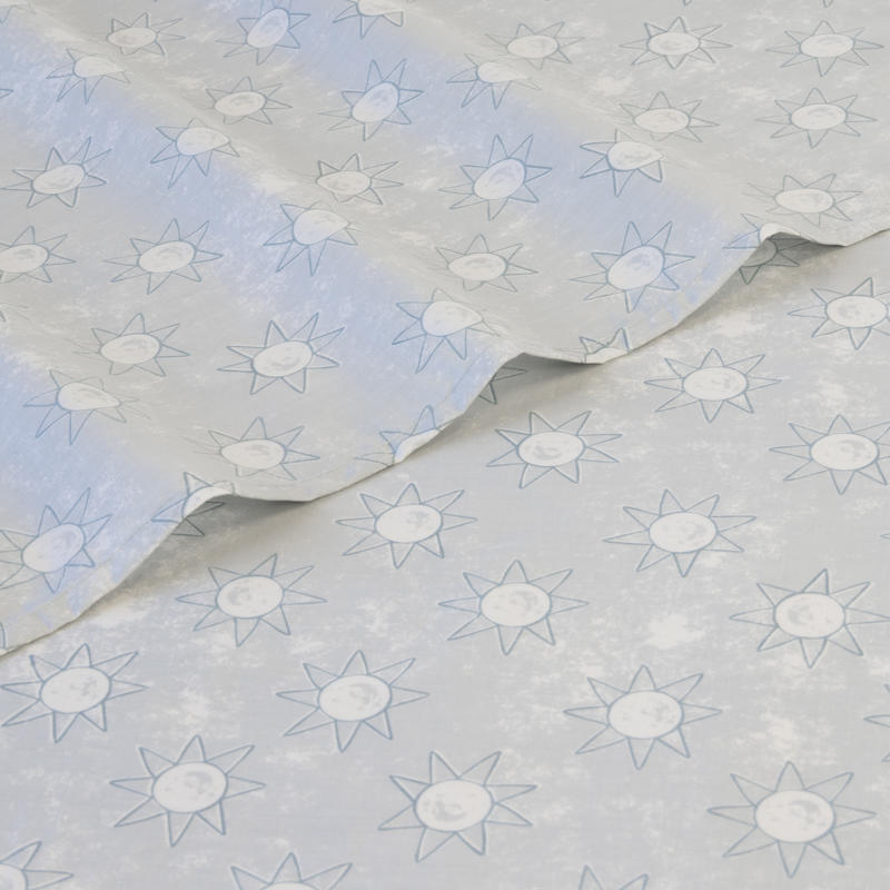 Close-up of playful blue sun print pattern on kids sheet set.