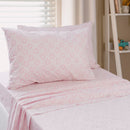 Close-up of playful pink sun print pattern on kids sheet set.