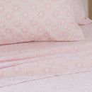 Close-up of playful pink sun print pattern on kids sheet set.