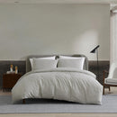 Kenneth Cole Herringbone Moss Quilt Cover Set styled on bed with neutral walls and modern décor.