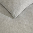 Kenneth Cole Herringbone Moss Quilt Cover Set styled on bed with neutral walls and modern décor.