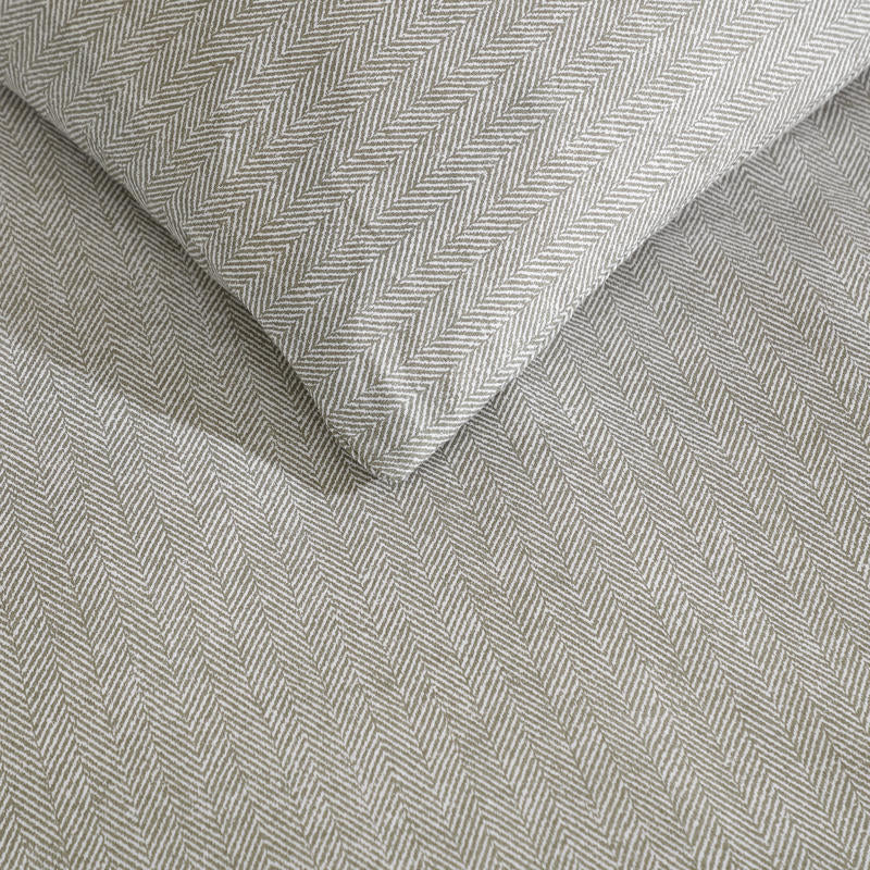 Kenneth Cole Herringbone Moss Quilt Cover Set styled on bed with neutral walls and modern décor.