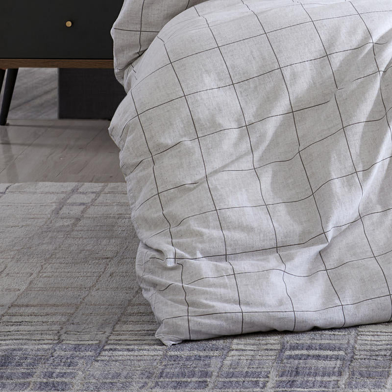 Close-up of grid pattern on Kenneth Cole Holden Grey Quilt Cover fabric.