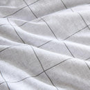 Close-up of grid pattern on Kenneth Cole Holden Grey Quilt Cover fabric.