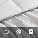 Reversible comforter showing light and dark grey tones.