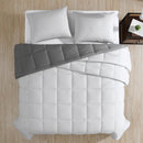 Reversible comforter showing light and dark grey tones.