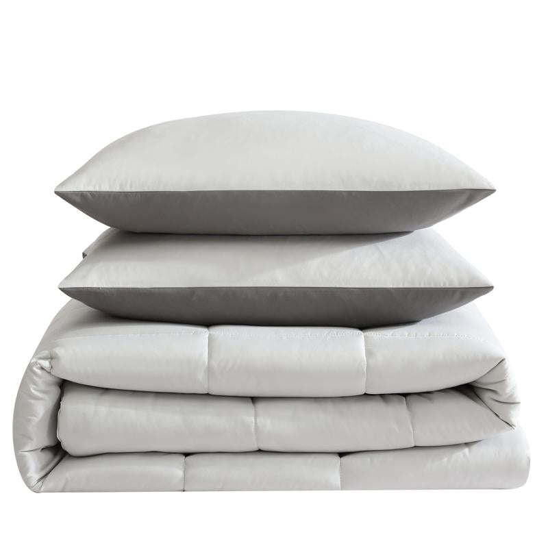 Reversible comforter showing light and dark grey tones.