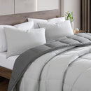 Reversible comforter showing light and dark grey tones.