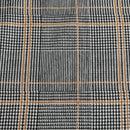 Kenneth Cole Sussex Khaki/Black Quilt Cover Set styled on bed with dark navy wall and wooden bedside table.