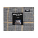 Kenneth Cole Sussex Khaki/Black Quilt Cover Set styled on bed with dark navy wall and wooden bedside table.