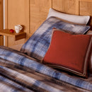 Bedroom styled with Lacoste L Denim Quilt Cover Set and rust accent cushions