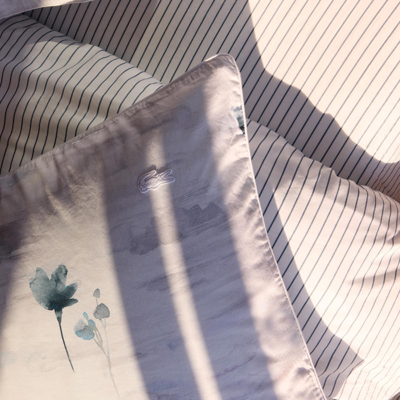 Bedroom styled with Lacoste L Shadow Quilt Cover Set in soft blue and grey tones