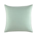 Close-up of Lacoste logo embroidered on geometric print fabric.