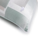 Close-up of Lacoste logo embroidered on geometric print fabric.