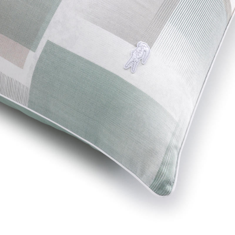 Close-up of Lacoste logo embroidered on geometric print fabric.