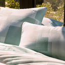 Bedroom styled with Lacoste L Songe Quilt Cover Set and neutral accent blanket.