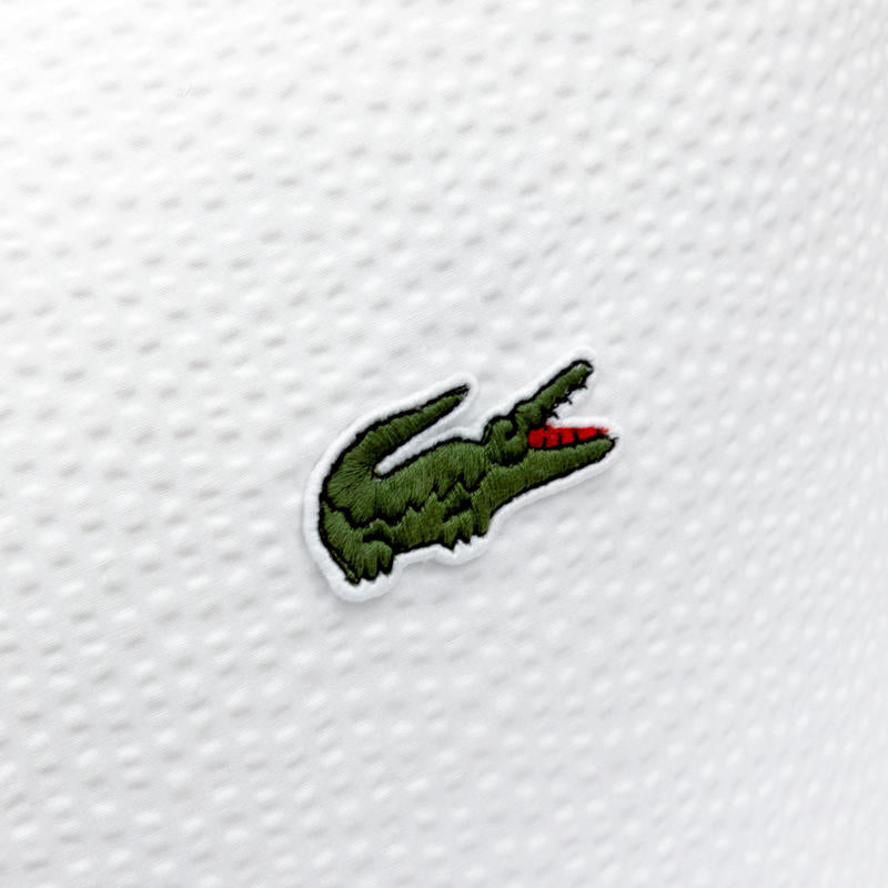 Lacoste L Tamis Blanc European Pillowcase in crisp white with green piping.