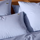 Close up of Lacoste L Tamis Sky Pillowcase texture and embroidered logo