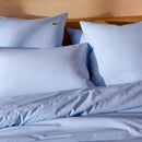 Lacoste L Tamis Sky Quilt Cover Set in soft blue with white piping and embroidered logo
